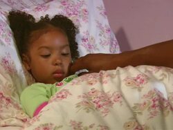 CU, father taking daughter's (4-5) temperature in bed, Westfield, New Jersey, USA Stock Footage