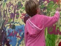 Childhood Accident: Young Girl Paints Mural, Splashes Eye Stock Footage