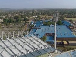 WS AERIAL Shot moving over stadium and nearby building / North West Province, South Africa Stock Footage