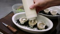 Chef applying sauce to oysters Stock Footage
