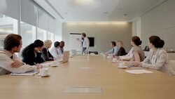 Businessman at flipchart leading meeting in conference room Stock Footage