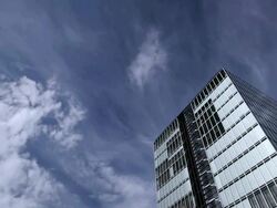 T/L Clouds above an office building / Cologne, North Rhine-Westphalia, Germany Stock Footage