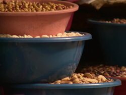 "Pan up of nuts, pulses, beans and olives in red and blue stacked bowls on market stall, Chachapoyas market, Chachapoyas, Peru [PerÃƒÂº]" Stock Footage
