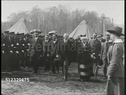1918: VISIT FROM PRESIDENT & QUEEN: President Woodrow Wilson walking w/ May (Mary of Teck) Queen Consort of Edward V & others through WWI soldier's camp. (Unable to tell which troops) Instructional Video