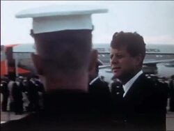 1962 US president John F. Kennedy walking in front of honor guard onboard USS Enterprise Stock Footage