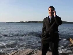 MS Man talking on mobile phone at ocean / Portland, ME, United States Stock Footage