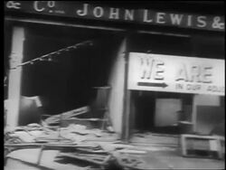 B/W 1940 PAN bombed out store with 'We Are Open' sign after London Blitz / educational Stock Footage