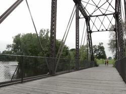 WS Two young girls running on bridge / Minneapolis, Minnesota, United States Stock Footage