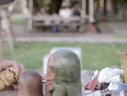 CU PAN Shot of Artist making Matryoshka doll at the park / Nerima, Tokyo, Japan Stock Footage
