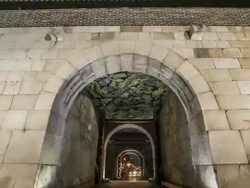 MS T/L POV Night view of Suwon Hwaseong Castle Janganmun Gate (Unesco World Heritage) and Entering Gate with crowded area / Suwon, Gyeonggi do, South Korea Stock Footage