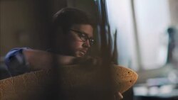 Young artisan polishes wooden skateboard with cloth in workshop Stock Footage