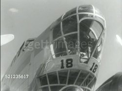 MOT 1939: ARMY GENERAL HEADQUARTERS: GHQ RECON: TU MS '21ST Reconnaissance Sqdn' sign w/ Greek god Mercury illustration painted above columned building entrance. MS GHQ Boeing B-18 'Bolo' bomber aircraft angle parked on field Instructional Video