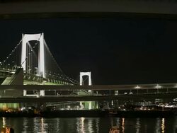WS T/L ZO View of Tokyo Rainbow Bridge and Monorail line at night / Minato, Tokyo, Japan Stock Footage