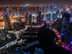 High view on Dubai Marina and Sheikh Zayed Road at night tilt Stock Footage