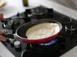 Cooking homemade pita bread. Turkish bezdirme or Indian paratha Stock Footage
