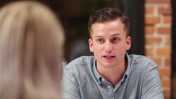 MS Smiling man in discussion with friend during dinner party Stock Footage