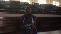 A basketball player dribbles from side to side and slam dunks a basketball in front of empty bleachers. Stock Footage