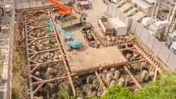 HD Time-lapse: Aerial view of working Excavator in Construction site Stock Footage