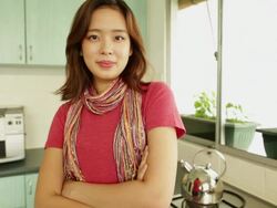 MS Portrait of Chinese woman in kitchen with arms folded Stock Footage