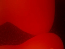 Red lava in light fixture shifts slowly, forms abstract shapes Stock Footage