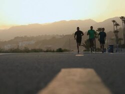 MS R/F Runner running on bike path at sunset / Los Angeles, California, United States Stock Footage