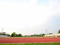 People jogging on track at sports stadium Stock Footage