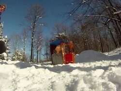 A young man snowboarding through trees and jumping over a playhouse. - Model Released - HD Stock Footage