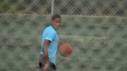 A young man basketball player dribbling before passing the ball to a teammate. - Slow Motion Stock Footage