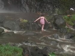 Girl crossing stormy waters Stock Footage