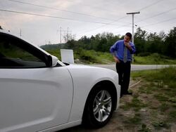 MS Man having  video teleconference via laptop on hood of car / Portland, ME, United States Stock Footage