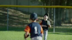 Medium panning shot of baseball outfielder catching ball / American Fork, Utah, United States Stock Footage