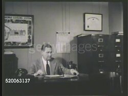 1935: NATIONAL CARBON COMPANY: MS Male entering office, 'National Carbon Co.... General Service Dept.' INT VS Male office worker at desk, female at filing cabinet looking over file. CU Complaint file 'Report of Prestone Anti-Freeze Investigation.' Instructional Video