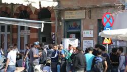 Syrian migrants fleeing the war and escaping to Europe, who have landed on the Greek island of Lesvos on the north coast at Efthalou, que to buy ferry tickets off the island. Up to 4,000 migrants a day are landing on the island and overwhelming the authori Stock Footage