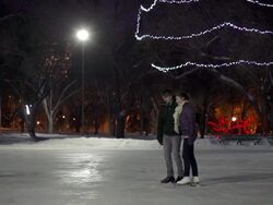 Couple has skating date on a winter evening. Stock Footage