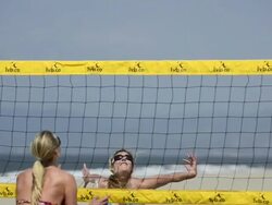 CU of female beach volleyball players spiking and blocking at the net. Stock Footage