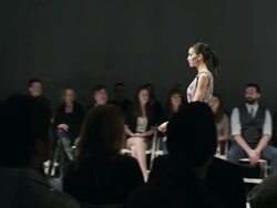 MS Female model walking alone on catwalk in front of crowd at fashion show Stock Footage