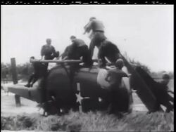 B/W 1960s soldiers on top of crashed helicopter / some jumping off / Vietnam War / documentary Stock Footage
