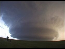MWA Huge supercell/thunder cloud, lightning flashes coming from within, above fields, USA Stock Footage