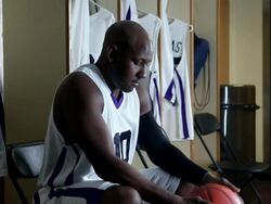 CU professional basketball player in locker room holding basketball preparing for game / Washington, USA Stock Footage