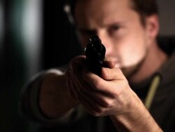 Man with gun looking at camera. Stock Footage