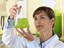 CU PAN Scientist in Biology Tech Laboratory Inspecting Liquid in Beaker / Eastville, Virginia, United States Stock Footage
