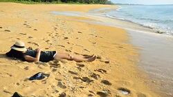 alone young woman taking a nap on beach Stock Footage