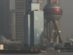 Ship sails through centre of Shanghai past magnificent buildings and skyscrapers, China Stock Footage
