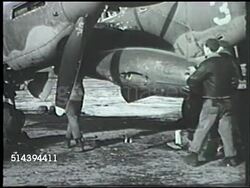 1943: ALEUTIAN ISLANDS CAMPAIGN: UNITED STATES ARMY: VS U.S. Navy soldiers fitting & loading artillery bomb shells onto medium size bombers on airbase at Amchitka, Alaska. VS Stockpile of artillery shells on field. WWII, World War II, Pacific Front Instructional Video