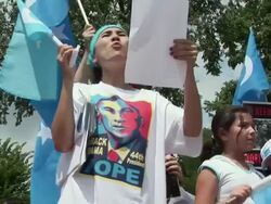 2009 MS LA Woman wearing Barack Obama, 'hope', t-shirt and leading slogans among protestors during an anti-China protest outside the White House in support of the Uygurs/ Washington D.C., USA/ AUDIO Stock Footage