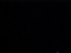 MWA low angle, Black sky, flashes of fork lightning lighting up sky, silhouetted telegraph pole, USA Stock Footage