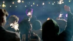 Wide dolly shot of lead guitar through party crowd with sparklers Stock Footage