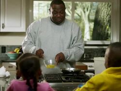 MS Dad pouring scrambled eggs into skillet while Daughter and son watching / Dallas, Texas, USA Stock Footage
