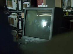 MS Shot of people reflection on old stacking television screens at warehouse / Lagos, Nigeria Stock Footage