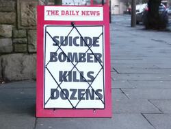 Newspaper Headline Board - Suicide Bomber kills dozens Stock Footage